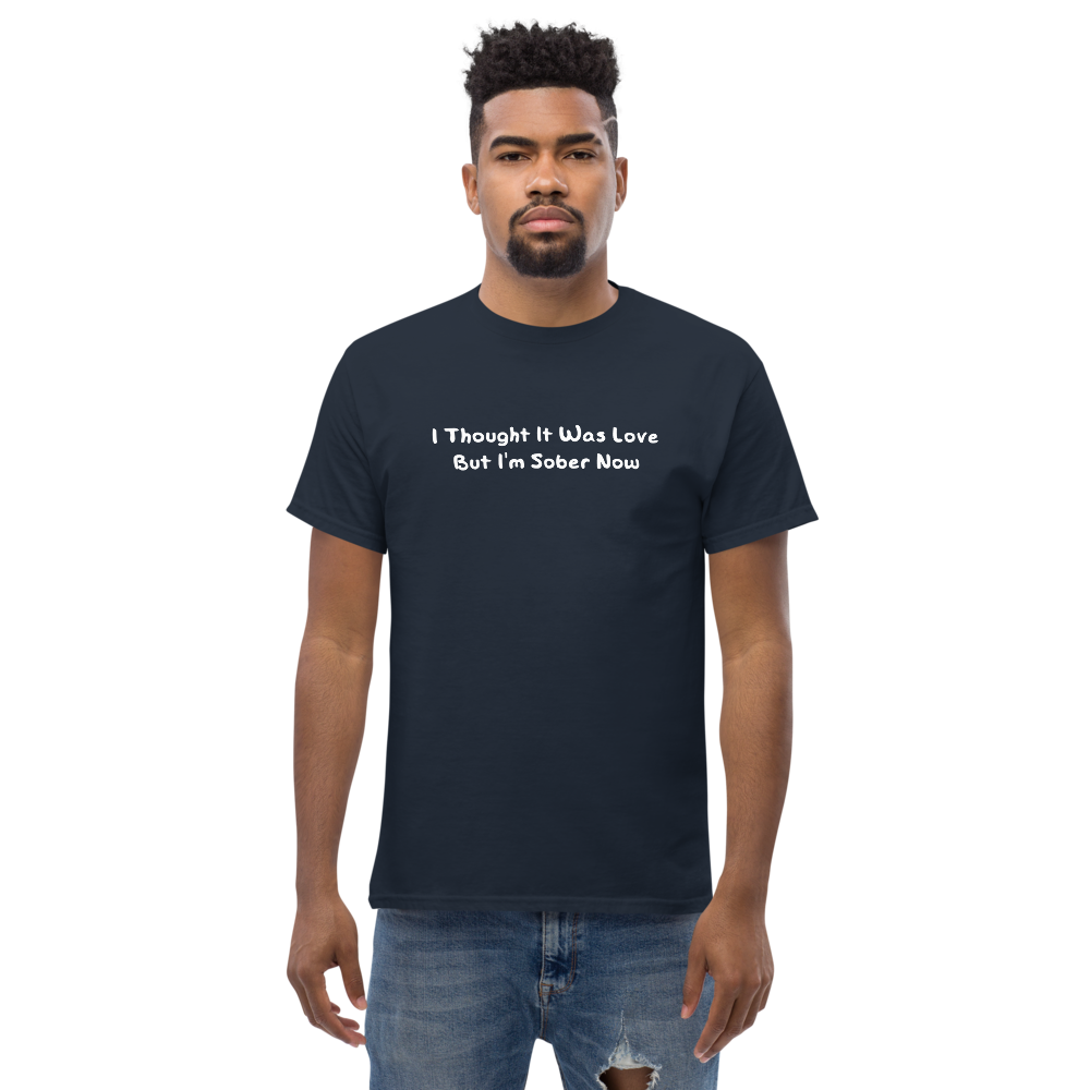 "I thought it was love but I’m sober now" printed on a navy unisex classic tee worn by a male