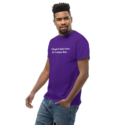 "I thought it was love but I’m sober now" printed on a purple unisex classic tee worn by a male