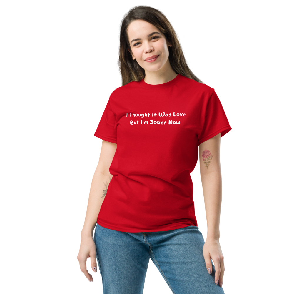 "I thought it was love but I’m sober now" printed on a red unisex classic tee worn by a female
