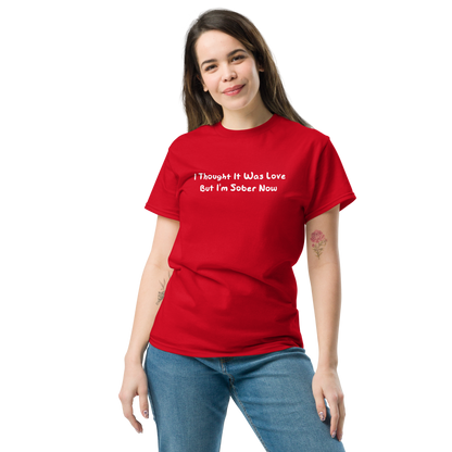 "I thought it was love but I’m sober now" printed on a red unisex classic tee worn by a female