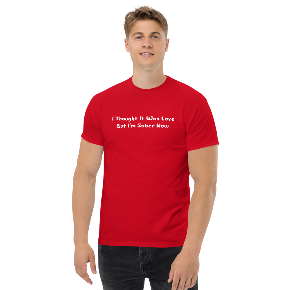 "I thought it was love but I’m sober now" printed on a red unisex classic tee worn by a male