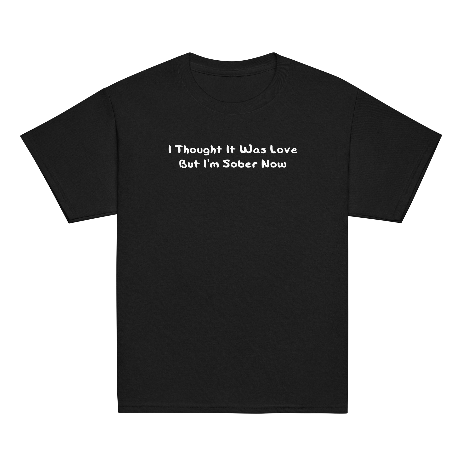 "I thought it was love but I’m sober now" printed on a black youth classic tee laying on a flat surface