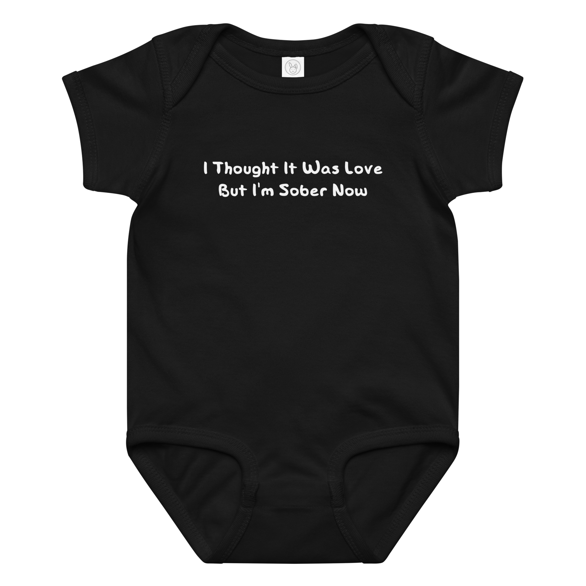 "I thought it was love but I’m sober now" printed on a black baby jersey bodysuit laying on a flat surface amongst other clothes