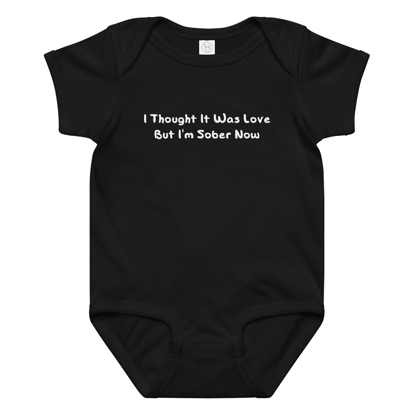 "I thought it was love but I’m sober now" printed on a black baby jersey bodysuit laying on a flat surface amongst other clothes