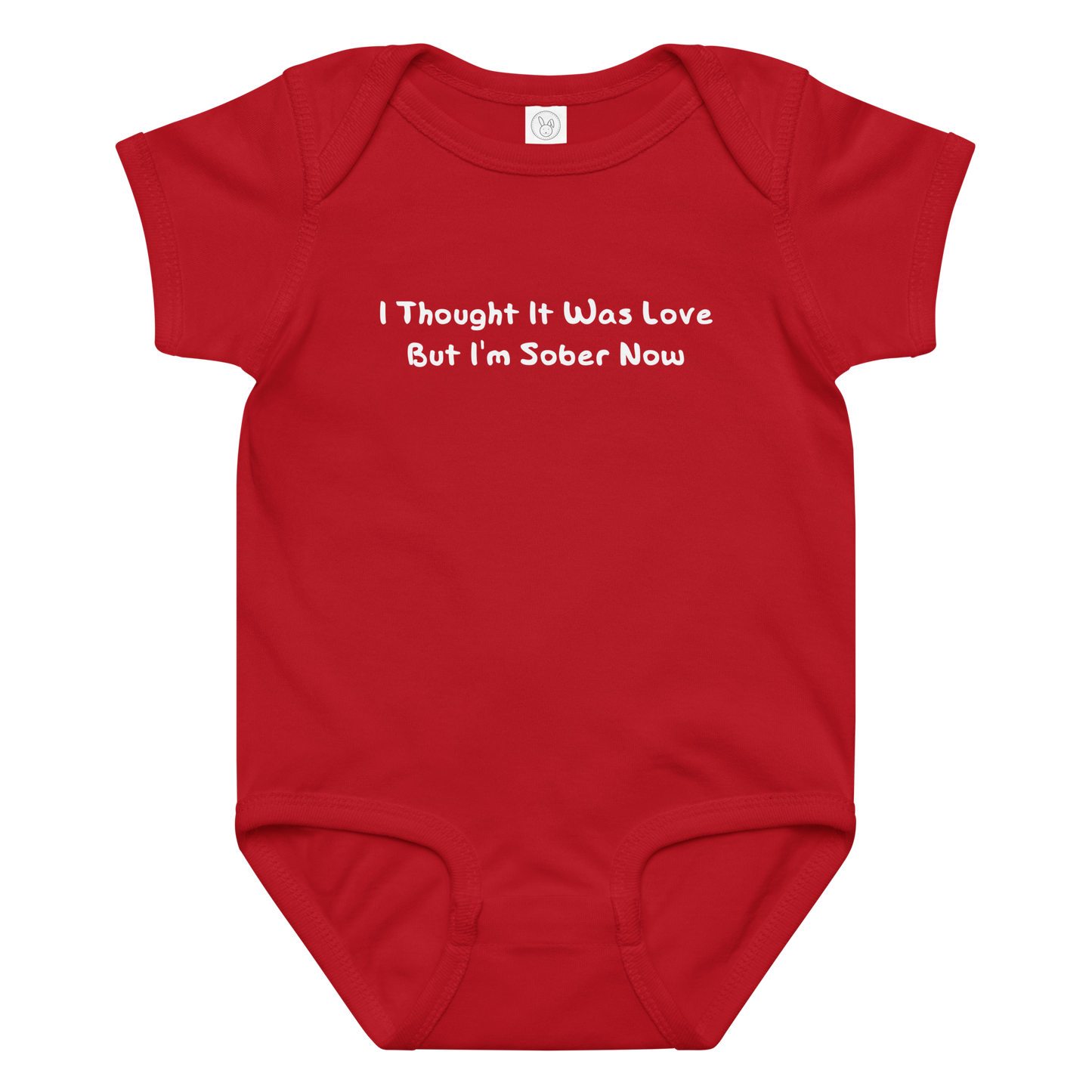 "I thought it was love but I’m sober now" printed on a red baby jersey bodysuit laying on a flat surface amongst other clothes