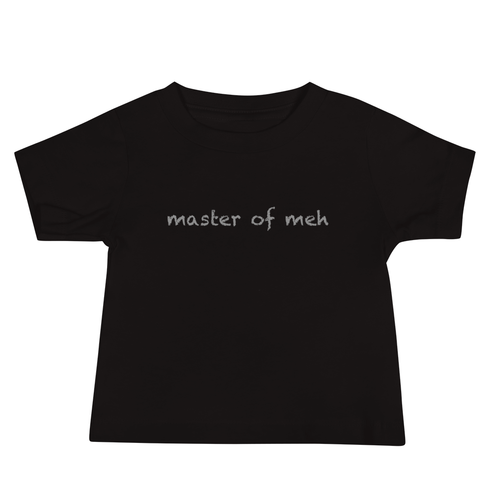 "Master of meh" printed on a black baby jersey short sleeve tee laying on a flat surface