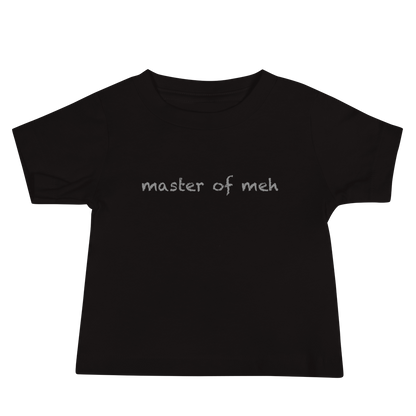"Master of meh" printed on a black baby jersey short sleeve tee laying on a flat surface
