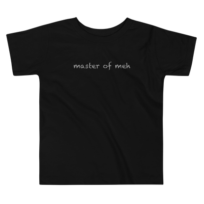 "Master of meh" printed on a black toddler short sleeve tee laying on a flat surface