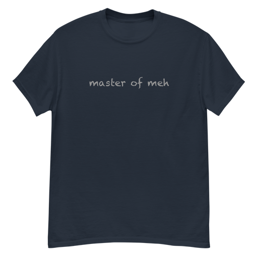 "Master of meh" printed on a navy unisex classic tee laying on a flat surface