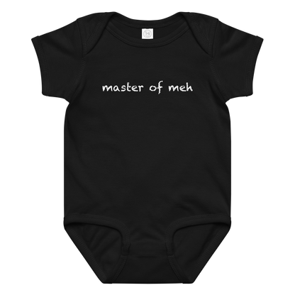 "Master of meh" printed on a black baby jersey bodysuit laying on a flat surface amongst other clothes