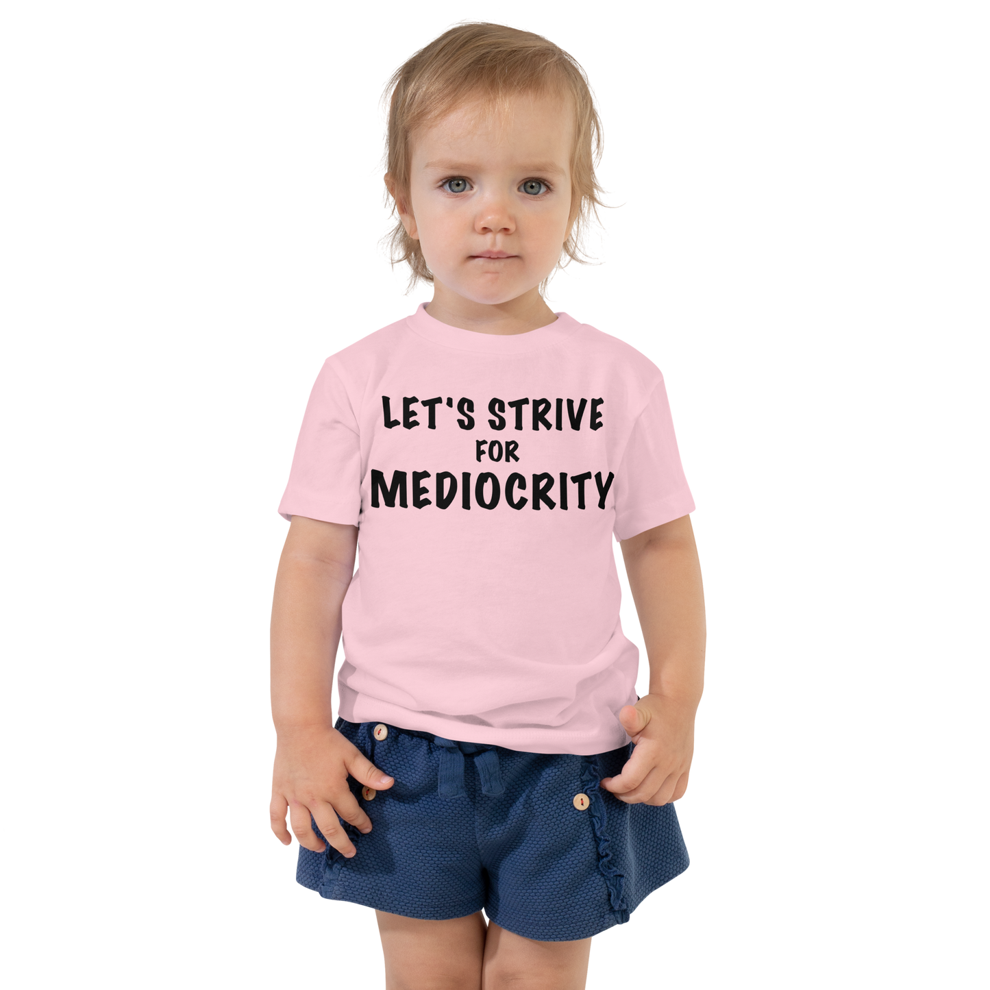 "Let's strive for mediocity" printed on a pink toddler short sleeve tee worn by a female
