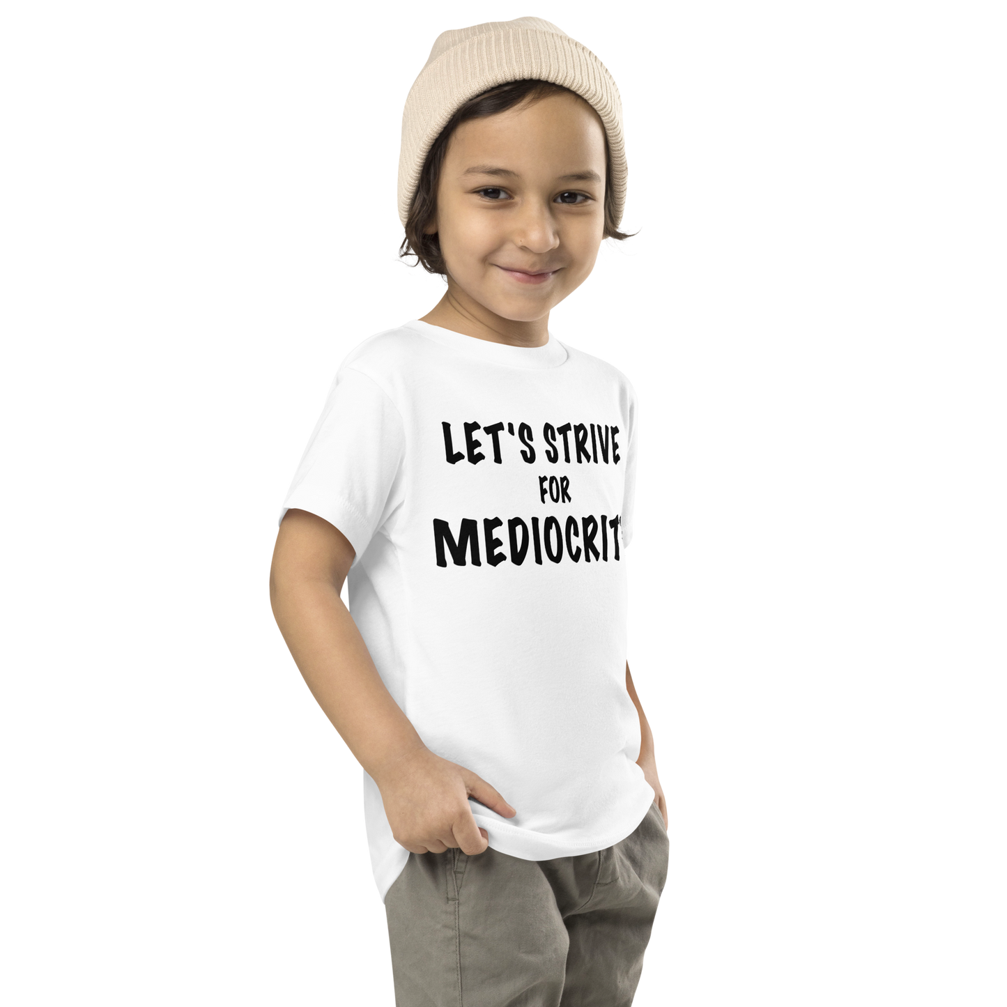 "Let's strive for mediocity" printed on a white toddler short sleeve tee worn by a male who is also wearing a knit cap