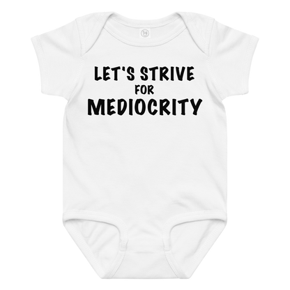 "Let's strive for mediocity" printed on a white baby jersey bodysuit laying on a flat surface amongst other clothes