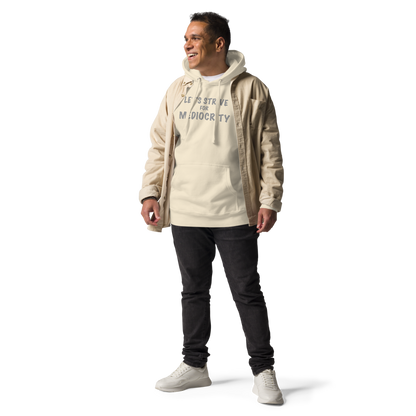"Let's strive for mediocity" printed on a bone unisex hoodie worn by a male with a jacket on top