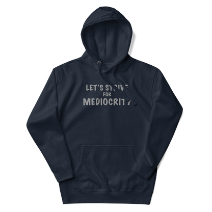"Let's strive for mediocity" printed on a navy blazer unisex hoodie laying on a flat surface with the hood up