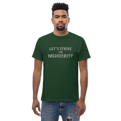 "Let's strive for mediocity" printed on a forest green unisex classic tee worn by a male