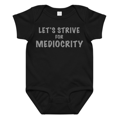 "Let's strive for mediocity" printed on a black baby jersey bodysuit laying on a flat surface amongst other clothes