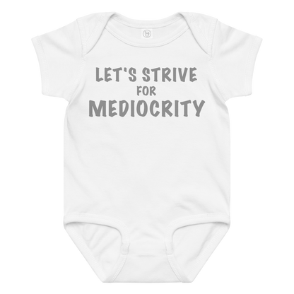 "Let's strive for mediocity" printed on a white baby jersey bodysuit laying on a flat surface amongst other clothes