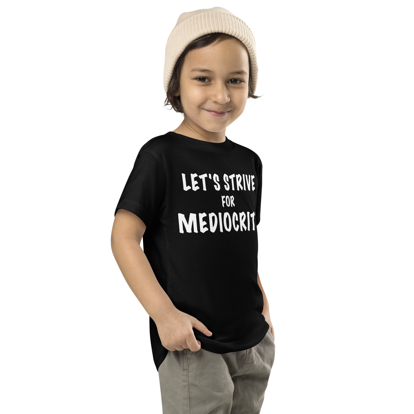 "Let's strive for mediocity" printed on a black toddler short sleeve tee worn by a male who is also wearing a knit cap