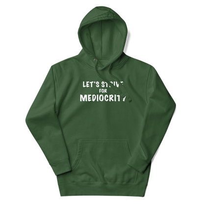 "Let's strive for mediocity" printed on a forest green unisex hoodie laying on a flat surface with the hood up