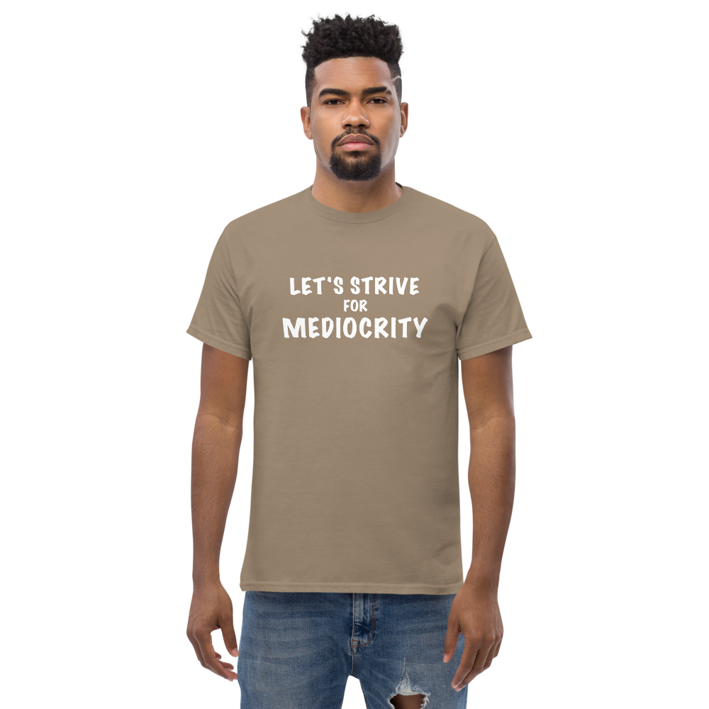 "Let's strive for mediocity" printed on a brown savana unisex classic tee worn by a male