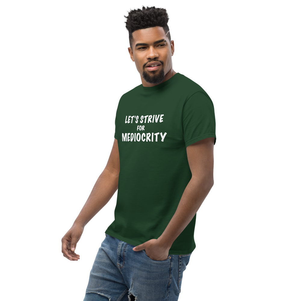 "Let's strive for mediocity" printed on a forest green unisex classic tee worn by a male