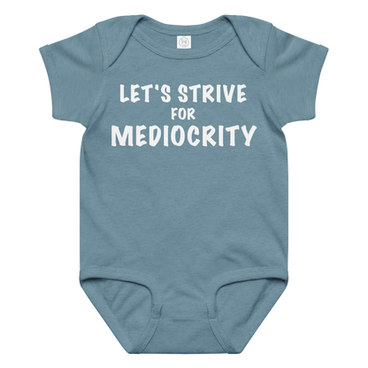"Let's strive for mediocity" printed on a vintage indigo baby jersey bodysuit laying on a flat surface amongst other clothes