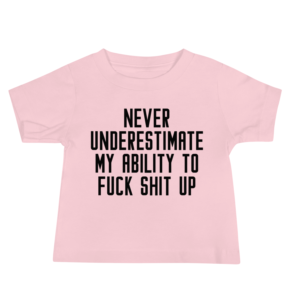 "Never Understimate My Ability To Fuck Shit Up" printed on a pink baby jersey short sleeve tee laying on a flat surface