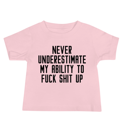 "Never Understimate My Ability To Fuck Shit Up" printed on a pink baby jersey short sleeve tee laying on a flat surface