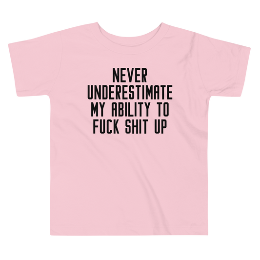 "Never Understimate My Ability To Fuck Shit Up" printed on a pink toddler short sleeve tee laying on a flat surface
