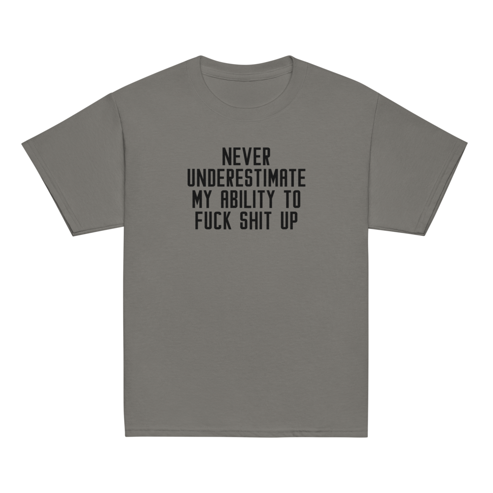 "Never Understimate My Ability To Fuck Shit Up" printed on a charcoal youth classic tee laying on a flat surface