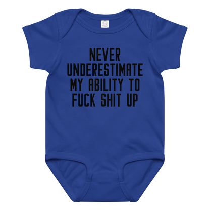 "Never Understimate My Ability To Fuck Shit Up" printed on a royal baby jersey bodysuit laying on a flat surface amongst other clothes