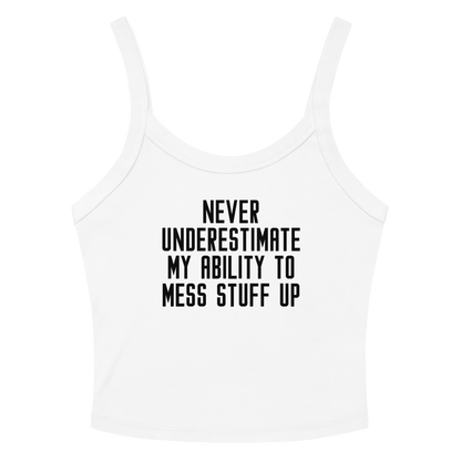 "Never Understimate My Ability To Mess Stuff Up" printed on a solid white blend women's micro-rib tanktop laying on a flat surface amongst sunglasses and shorts