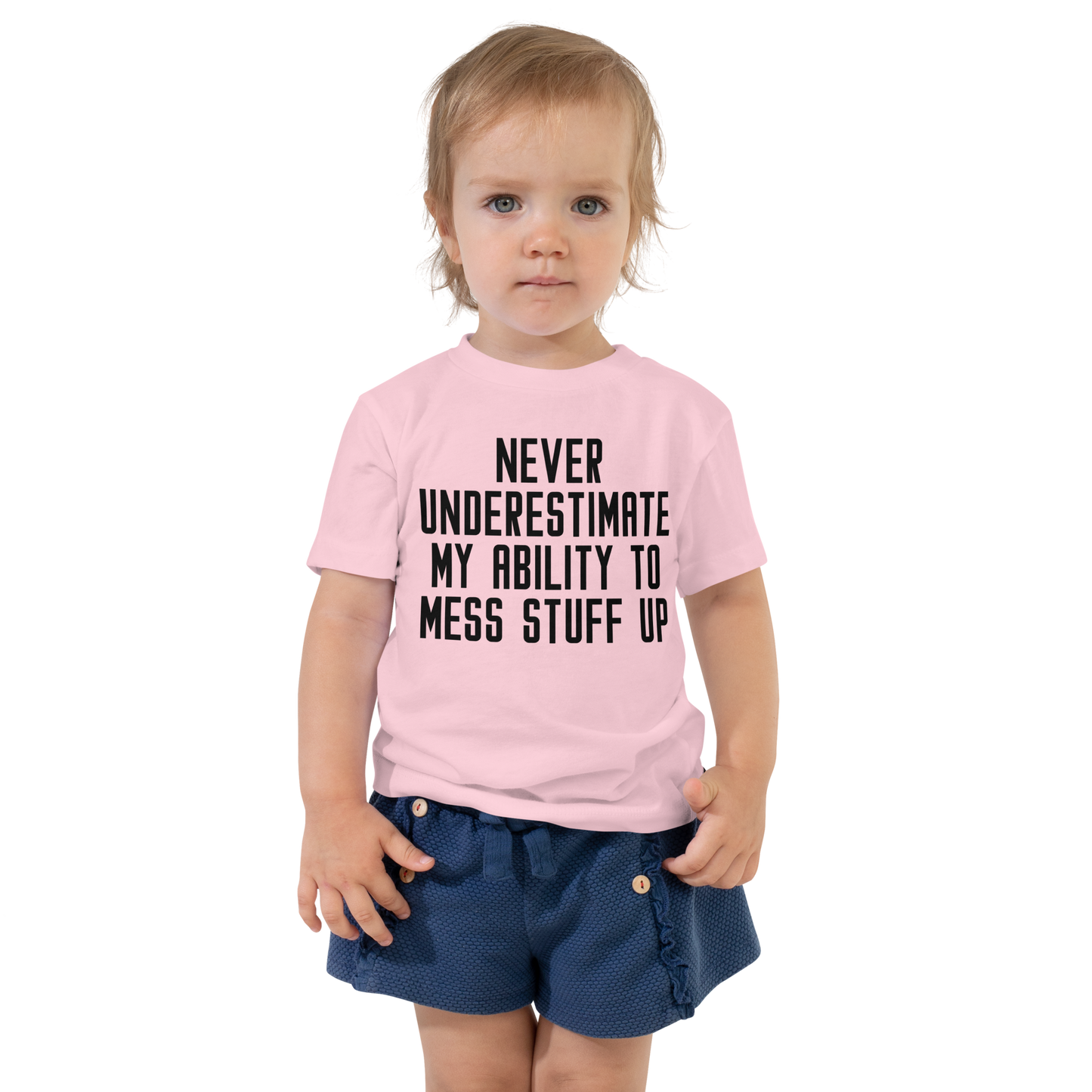 "Never Understimate My Ability To Mess Stuff Up" printed on a pink toddler short sleeve tee worn by a female
