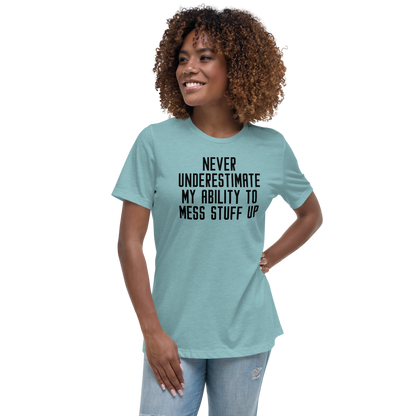"Never Understimate My Ability To Mess Stuff Up" printed on a heather blue lagoon women's relaxed t-shirt worn by a female