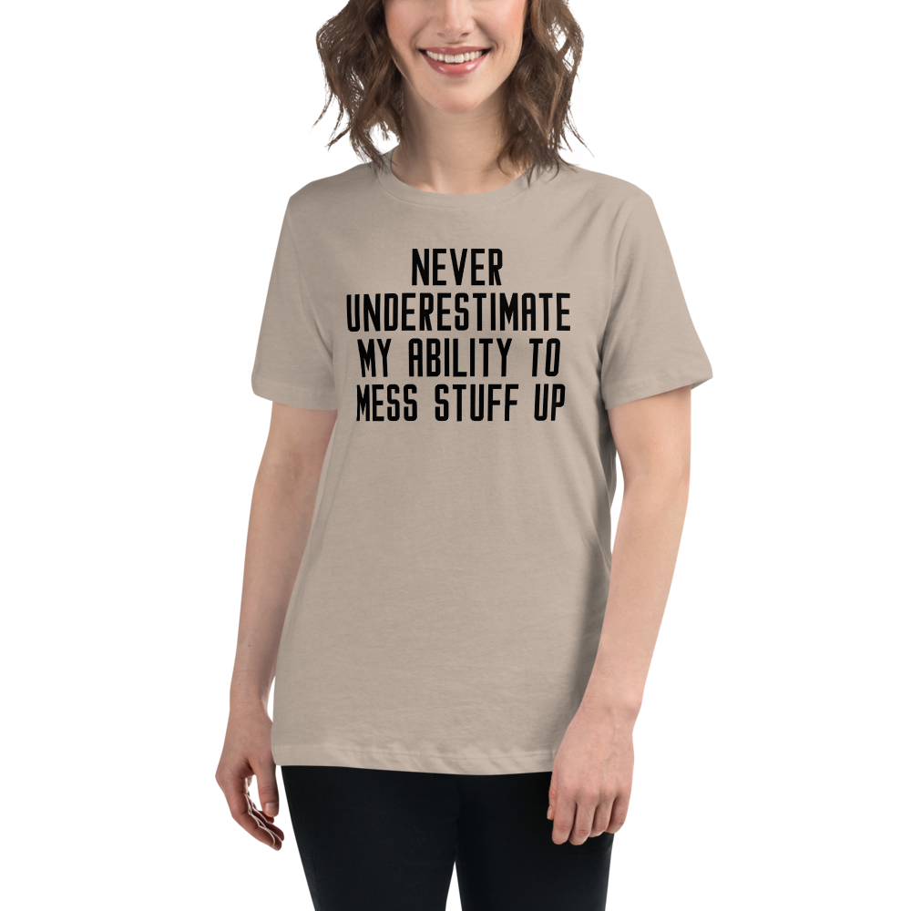 "Never Understimate My Ability To Mess Stuff Up" printed on a heather stone women's relaxed t-shirt worn by a female
