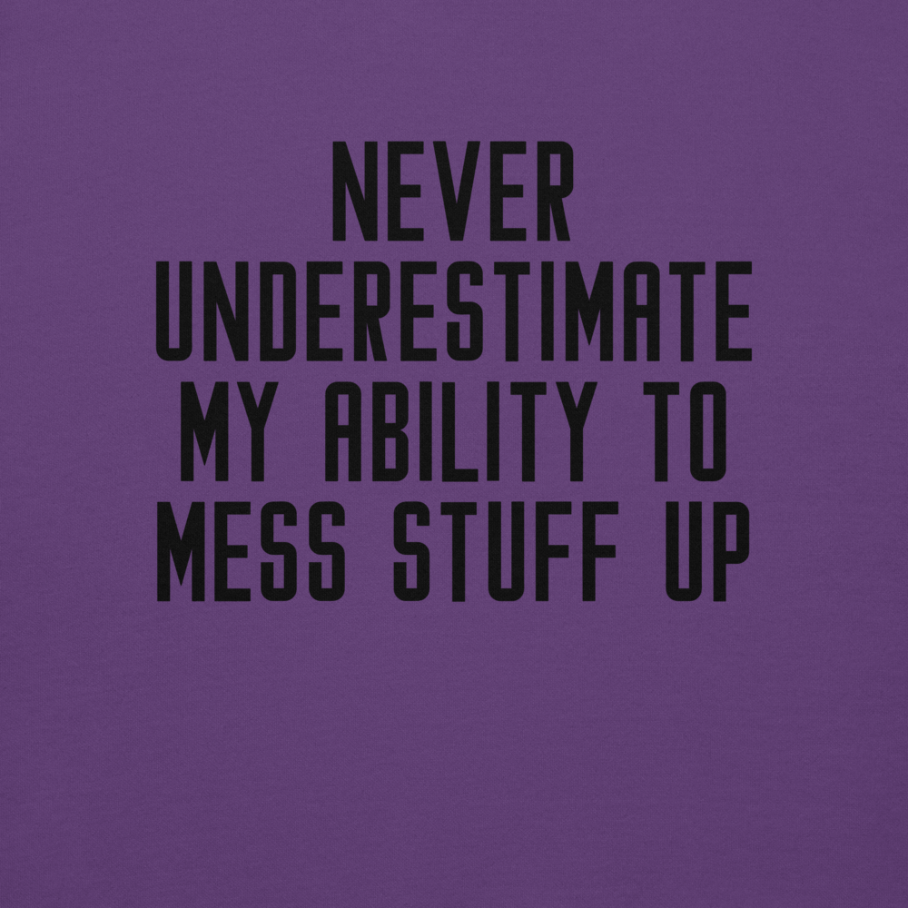 "Never Understimate My Ability To Mess Stuff Up" printed on a purple background