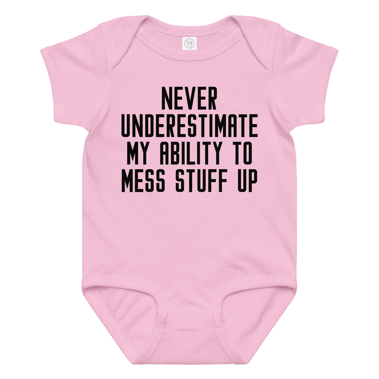 "Never Understimate My Ability To Mess Stuff Up" printed on a pink baby jersey bodysuit laying on a flat surface amongst other clothes