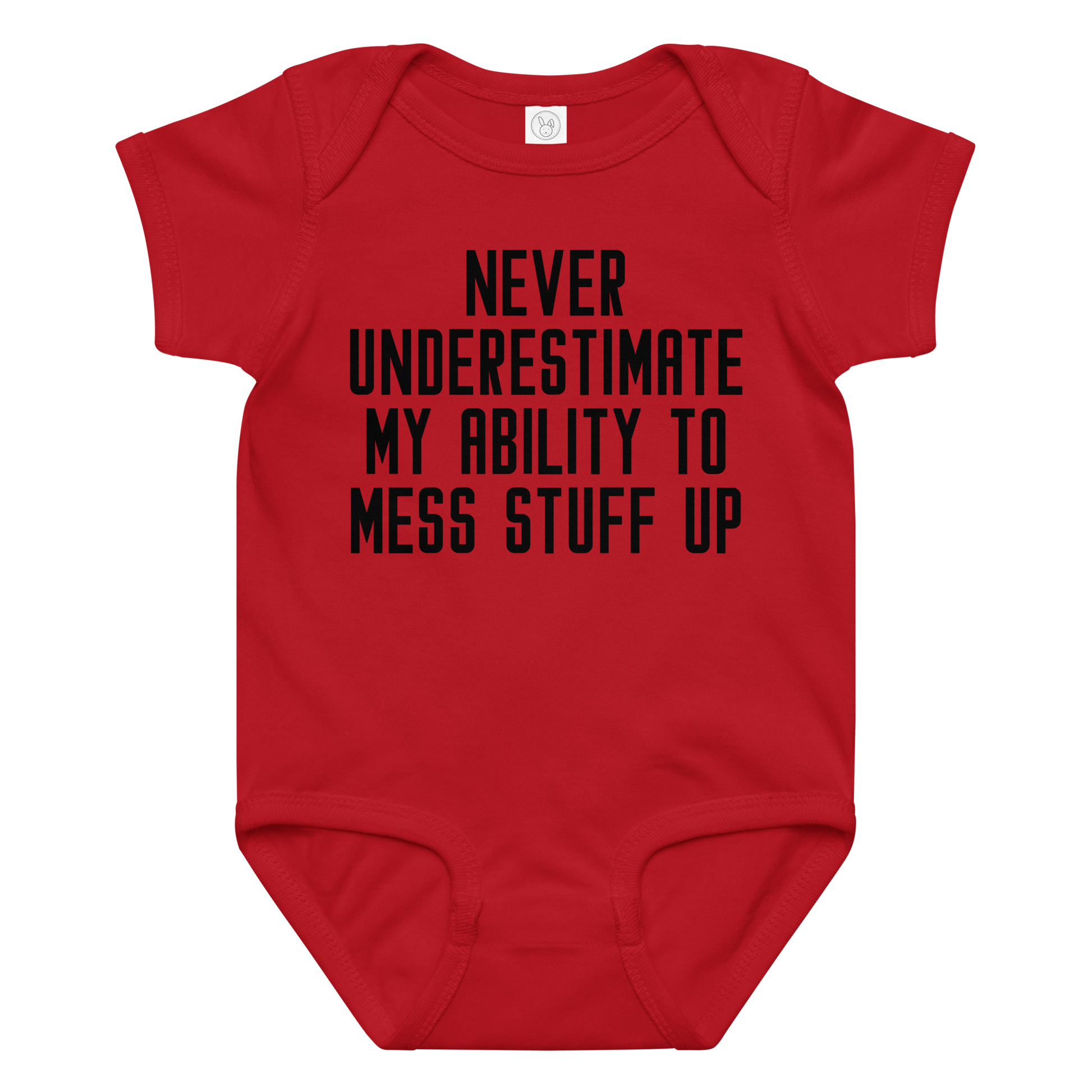 "Never Understimate My Ability To Mess Stuff Up" printed on a red baby jersey bodysuit laying on a flat surface amongst other clothes