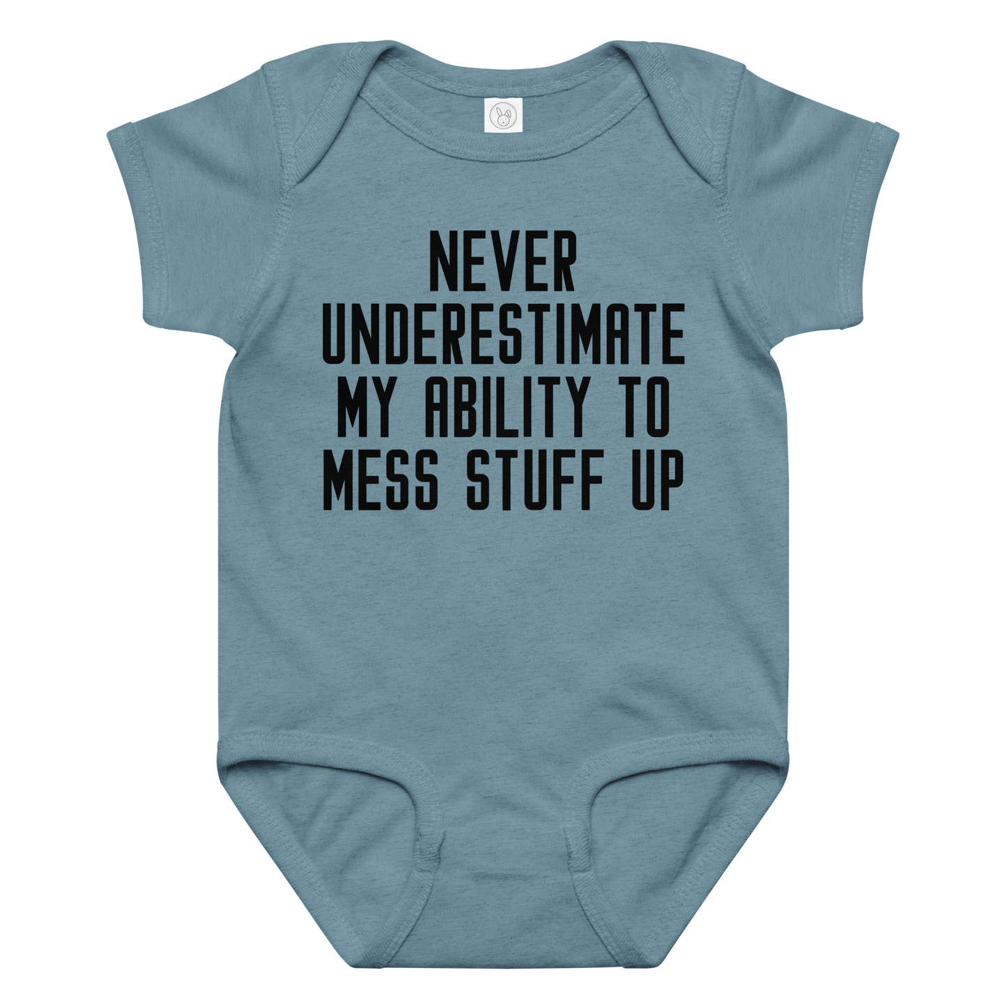 "Never Understimate My Ability To Mess Stuff Up" printed on a vintage indigo baby jersey bodysuit laying on a flat surface amongst other clothes
