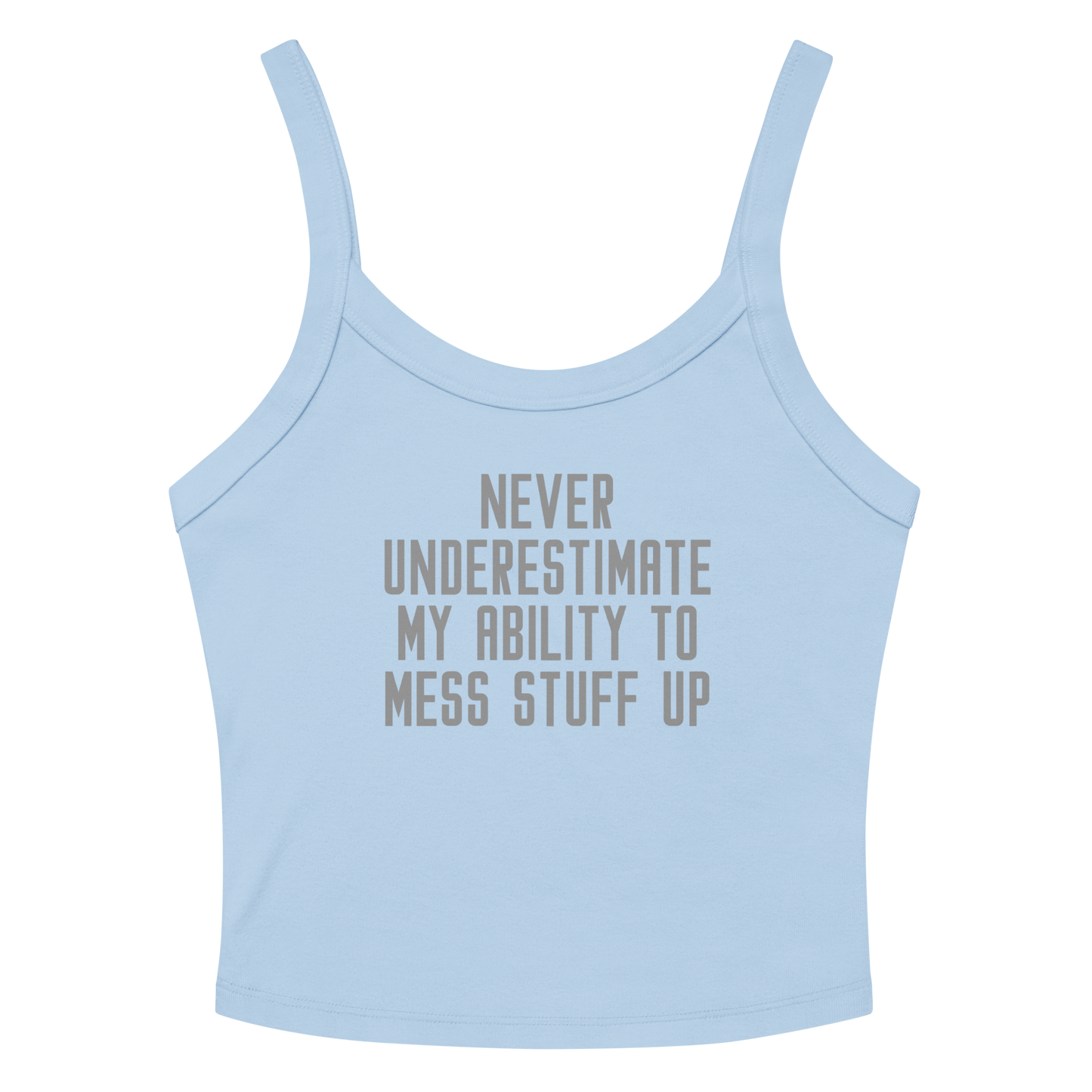 "Never Understimate My Ability To Mess Stuff Up" printed on a solid baby blue blend women's micro-rib tanktop laying on a flat surface amongst sunglasses and shorts