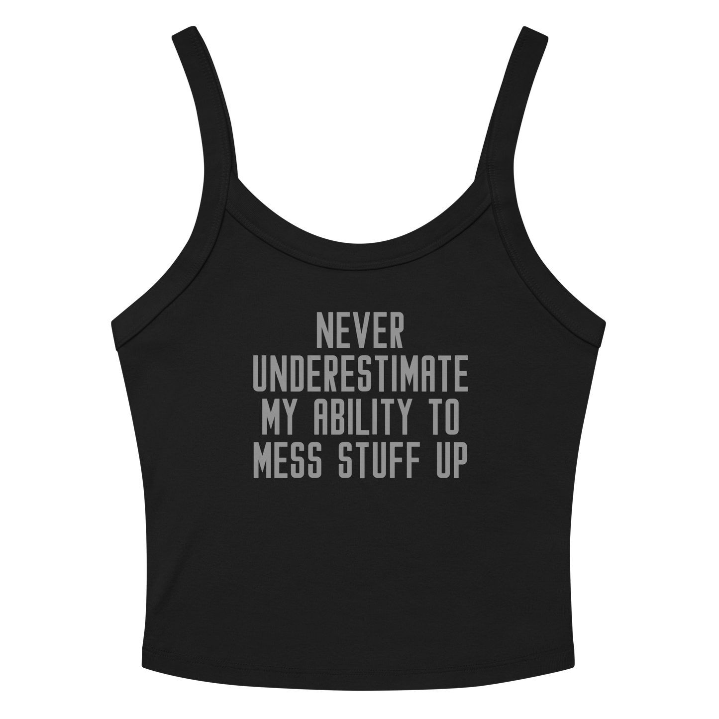 "Never Understimate My Ability To Mess Stuff Up" printed on a solid black blend women's micro-rib tanktop laying on a flat surface amongst sunglasses and shorts