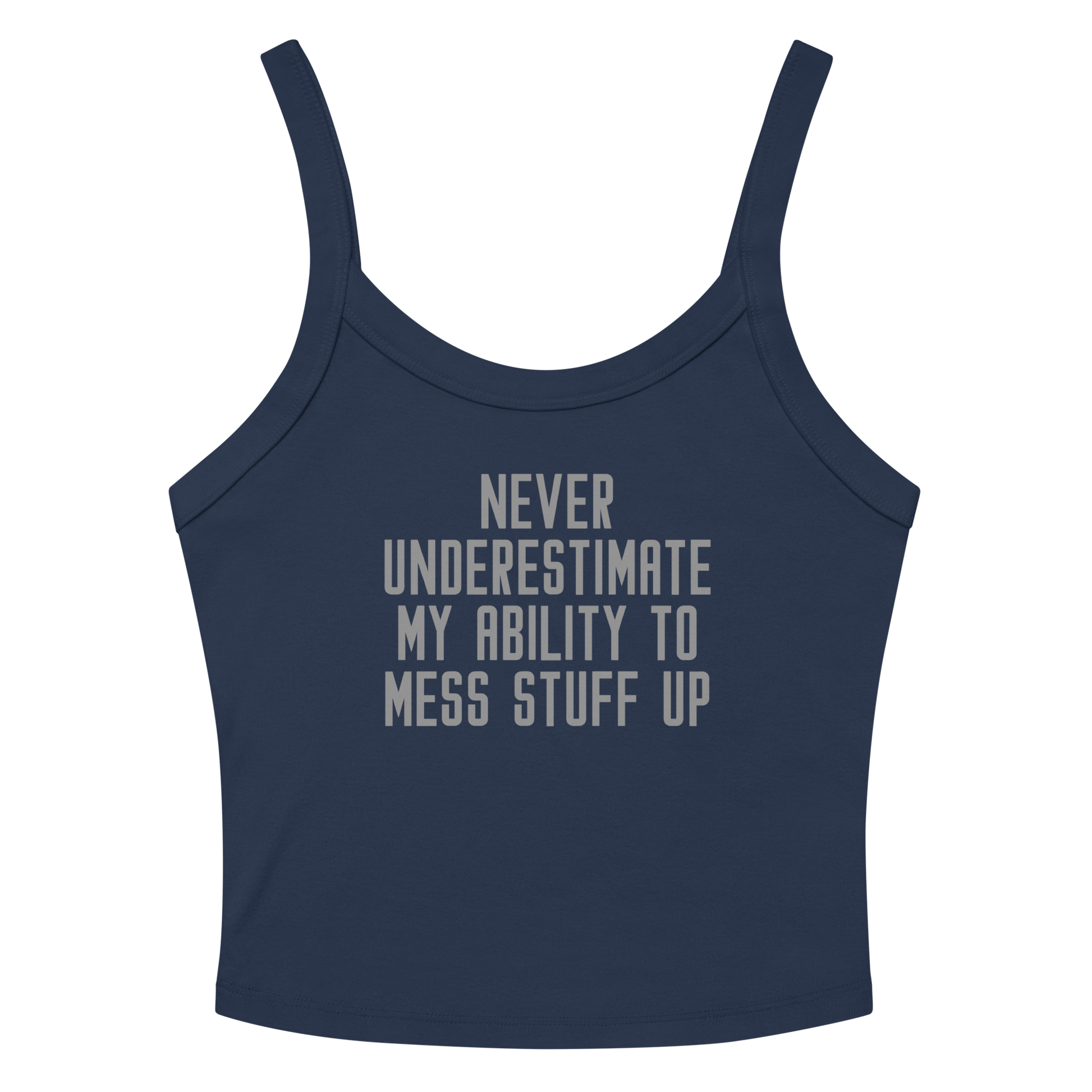 "Never Understimate My Ability To Mess Stuff Up" printed on a solid navy blend women's micro-rib tanktop laying on a flat surface amongst sunglasses and shorts