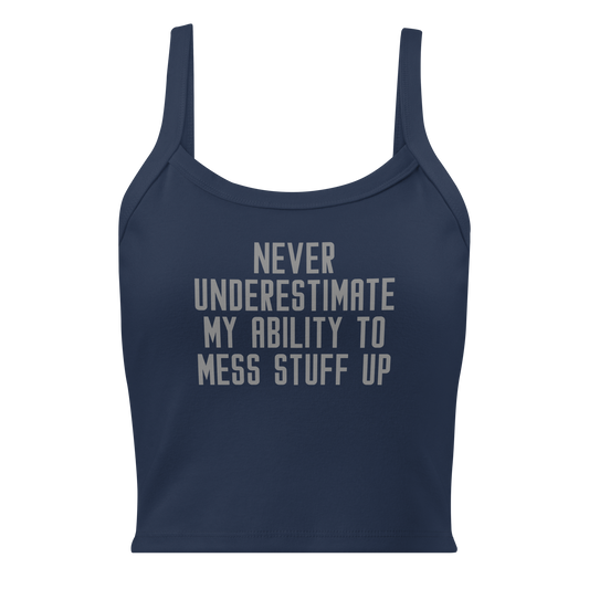 "Never Understimate My Ability To Mess Stuff Up" printed on a solid navy blend women's micro-rib tanktop laying on a flat surface