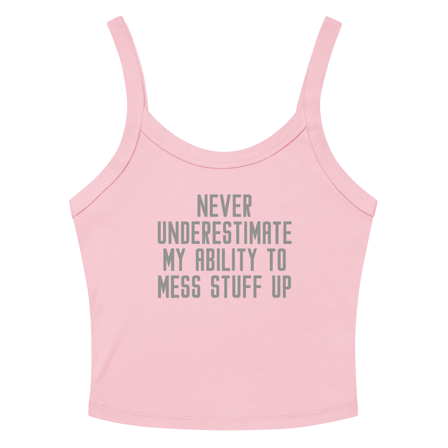 "Never Understimate My Ability To Mess Stuff Up" printed on a solid pink blend women's micro-rib tanktop laying on a flat surface amongst sunglasses and shorts