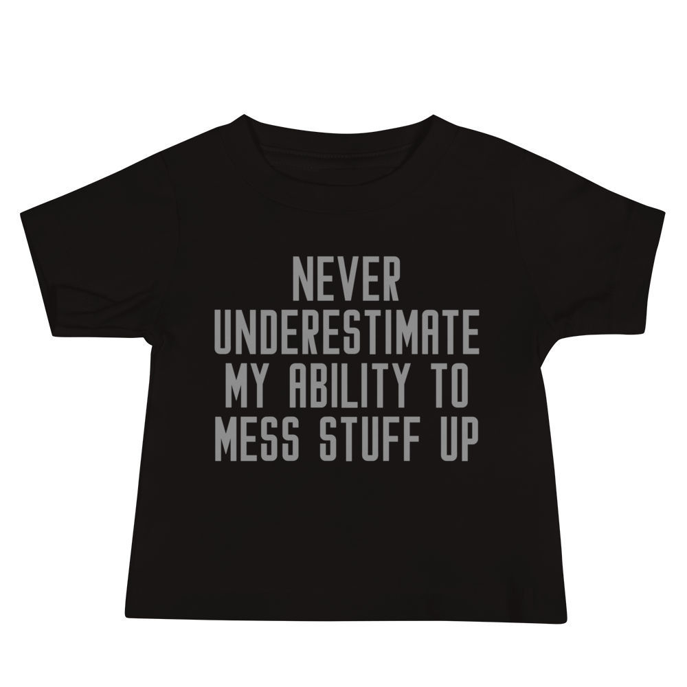 "Never Understimate My Ability To Mess Stuff Up" printed on a black baby jersey short sleeve tee laying on a flat surface