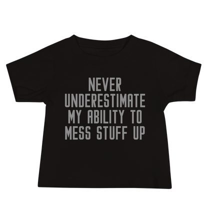 "Never Understimate My Ability To Mess Stuff Up" printed on a black baby jersey short sleeve tee laying on a flat surface