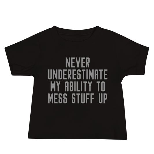 "Never Understimate My Ability To Mess Stuff Up" printed on a black baby jersey short sleeve tee laying on a flat surface