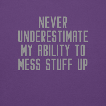 "Never Understimate My Ability To Mess Stuff Up" printed on a purple background