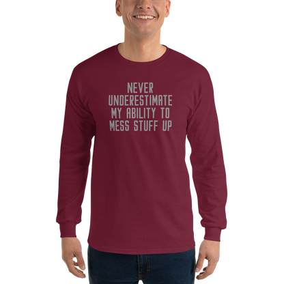 "Never Understimate My Ability To Mess Stuff Up" printed on a maroon men's long sleeve shirt worn by a male